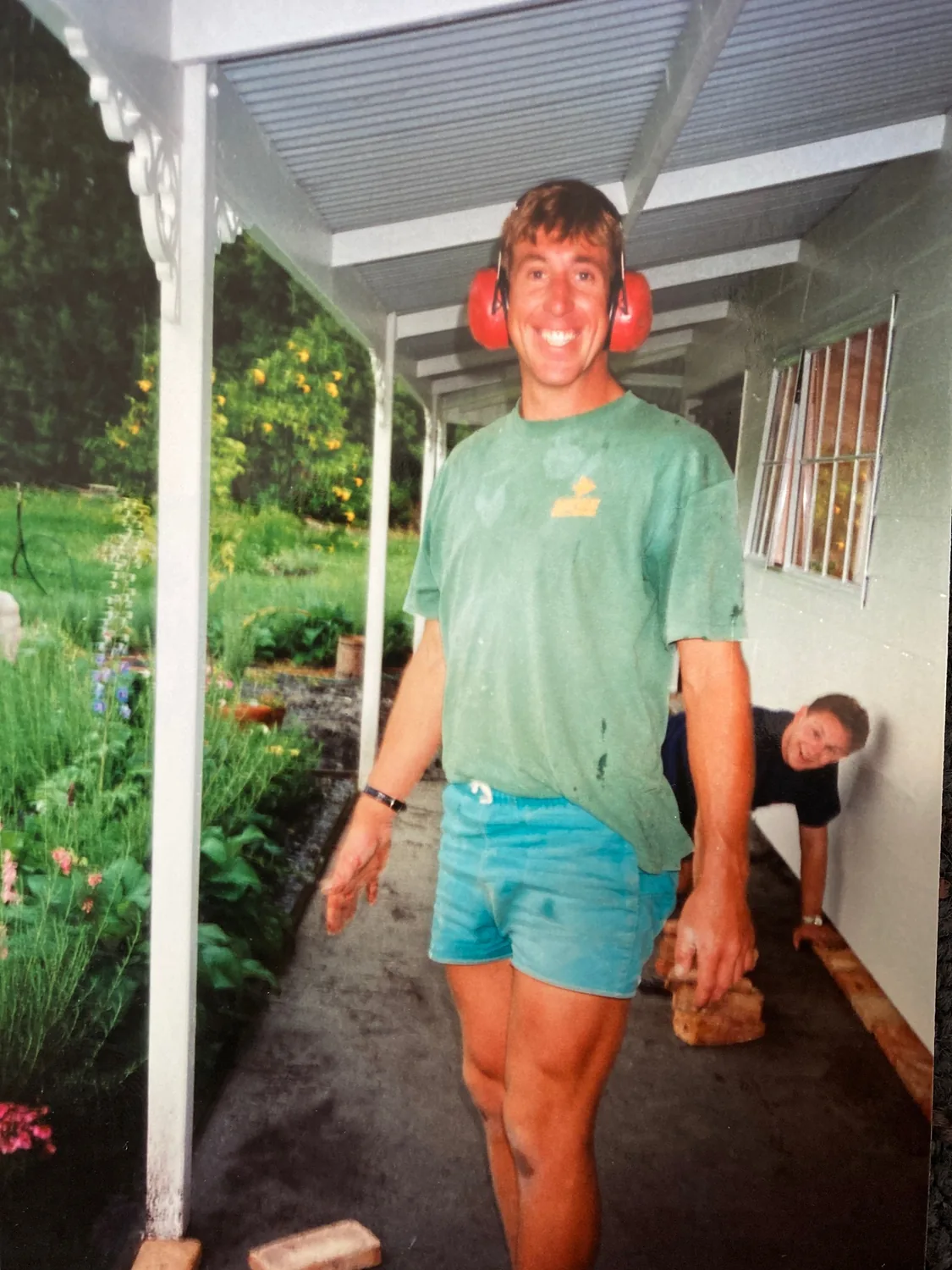 Mike Bell on a Belco Homes job in 1996 wearing ear muffs, shorts and a t-shirt