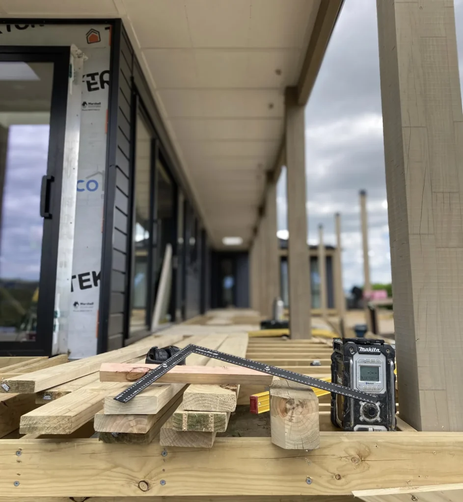 Timber, a square and a level on the deck of a minor dwelling under construction near Tauranga